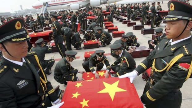 Chinese soldiers hold caskets containing the remains of members of the Chinese People's Volunteers (CPV) in Shenyang, Liaoning province.