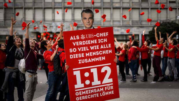Ideal ratio: A placard shows the face of the CEO of Swiss banking giant UBS Sergio Ermotti as members of the Swiss Social Democrats youth wing demonstrate in Zurich in favour of "1:12".