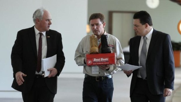 DLP Senator John Madigan (left) and Independent Senator Nick Xenophon (right) together with Rossi Boots CEO Neville Hayward (centre). 