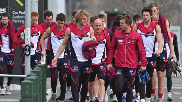 On the march: Melbourne players arrive at training yesterday at AAMI Park.