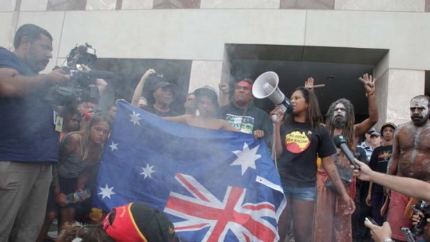 Heat of the moment &#8230; the Australian flag is burnt by Aboriginal protesters at the front of Parliament House.