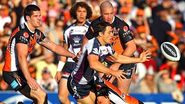 Cooper Cronk clears the ball to supporting Storm teammates.