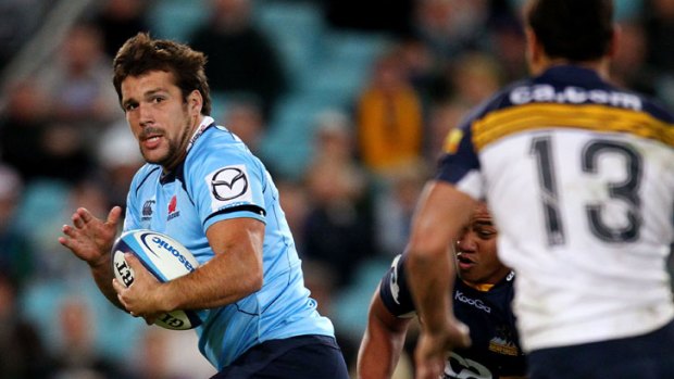 Chris Alcock heads for the tryline to score for the Waratahs on Saturday night.