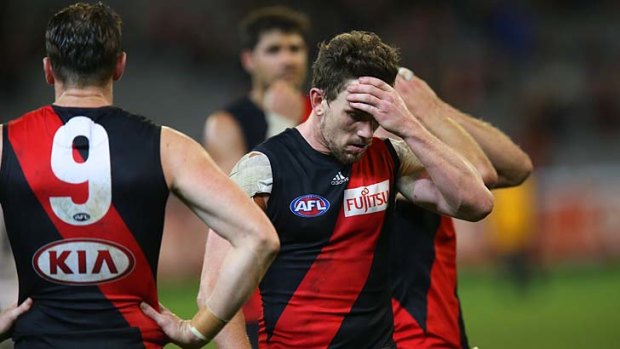Suffering on and off the field: the Bombers trudge off after succumbing to Melbourne.