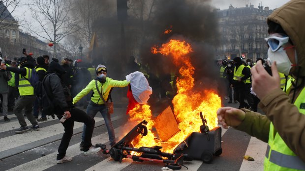 Demonstrators set a fire on the Place de la Republique after a yellow vest protest