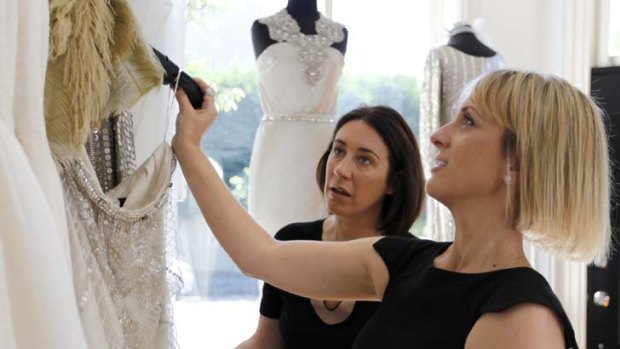 Dress up ... editor Edwina McCann (left) looks at gowns with designer Johanna Johnson.