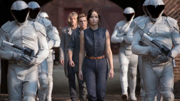 Role model ... Jennifer Lawrence portrays Katniss Everdeen, left, and Liam Hemsworth portrays Gale Hawthorne in <i>The Hunger Games</i>.