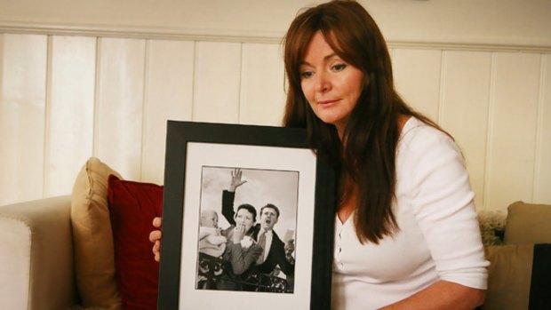 Marisa Robbins holds an old photo of her parents, Lloyd and Mary Martin, who died fighting to save their Humevale home.