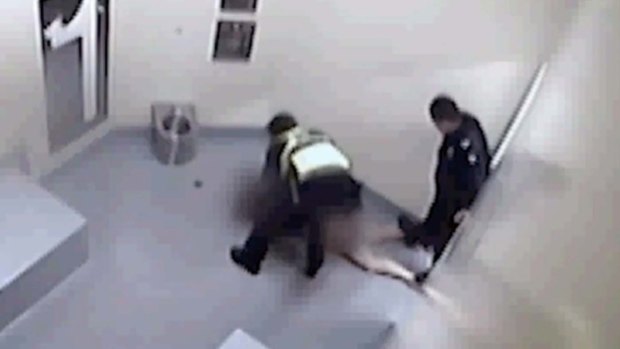 Video still shows a police officer standing on a woman's legs while she is in custody in Ballarat.
