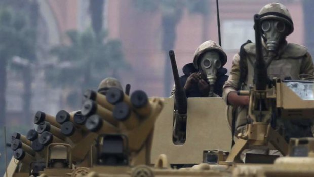 Soldiers riding armoured personnel carriers  arrive at Tahrir Square after clashes with pro-Mursi protesters in Cairo December.