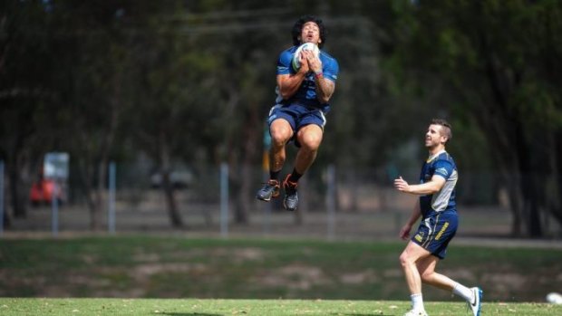 Leap of fatih: Joe Tomane, jumping left, will return to the ACT Brumbies team after being baptised last weekend. 