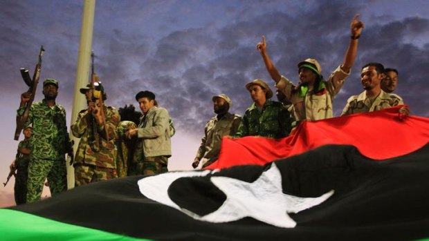 Anti-Gaddafi fighters gesture to the crowds during celebrations.