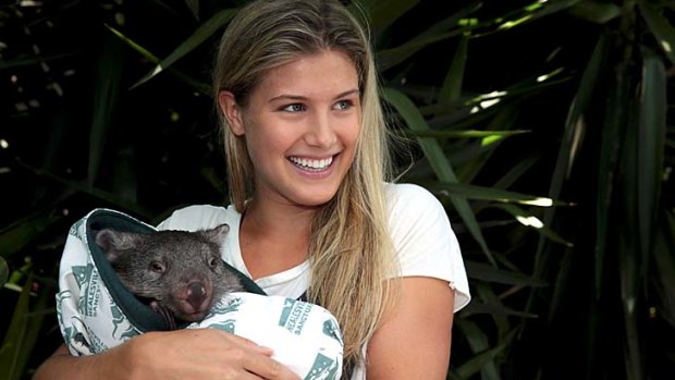 Eugenie Bouchard of Canada poses with a baby wombat from Melbourne Zoo.