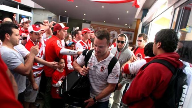 Red army ... Dean Young and teammates arrive at the Wollongong Entertainment Centre to meet about 2000 fans yesterday.