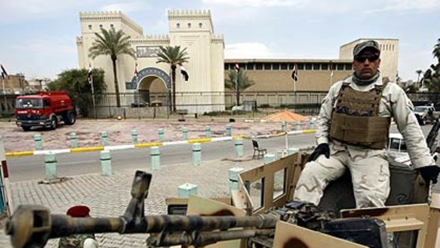 New hope . . . an Iraqi security officer stands guard outside the National Museum that has been reopened after six years.