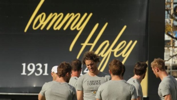 Richmond players at training at Punt Road on Friday, with a tribute to Hafey in the background.