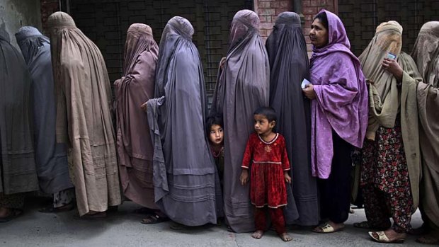 Election day: A queue of women at an Islamabad polling station. Women were banned from voting in part of Pakistan.