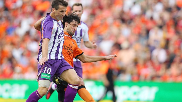 Perth Glory's Liam Miller gets in a tangle with Brisbane Roar's Thomas Broich in the first half of today's A-League Grand Final.