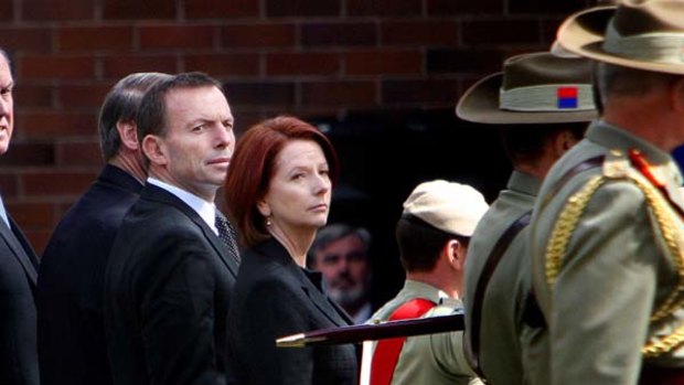 Sombre ... Tony Abbott and Julia Gillard attend the funeral for Trooper Jason Brown.