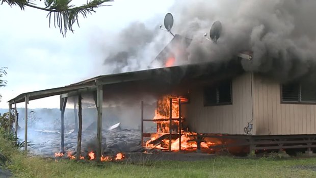 Lava burns the first home in Pahoa.