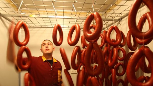 Sausages that sizzle ... Anil Gunaydin, with sucuk sausages, at his family's butchery in Mascot.