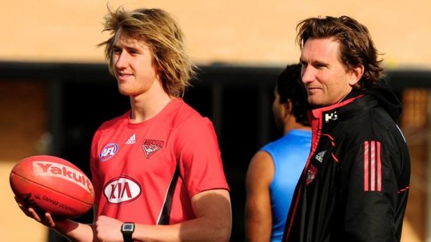 Essendon's Dyson Heppell and coach James Hird during a light training session.