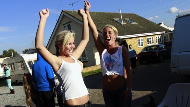 Travellers celebrate after hearing of a court injunction before evictions at the Dale Farm traveller site.