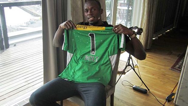 Usain Bolt, pictured here with a Melbourne Stars shirt, would love to try his hand at cricket.