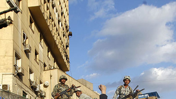 A protester raises his fist in front of an army armoured personnel carrier in Cairo's Tahrir Square.