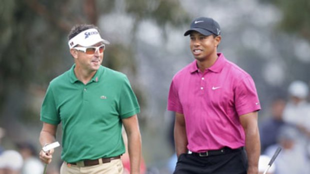 Australian star Robert Allenby and Tiger Woods stroll the fairways during the first round of the Australian Masters at Victoria Golf Club.