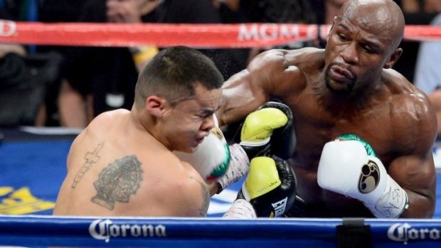 Floyd Mayweather Jr lands a right punch on Marcos Maidana in a bout last month.