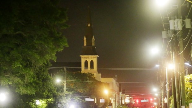 The steeple of Emanuel AME Church is visible as police close off the street after the shooting.