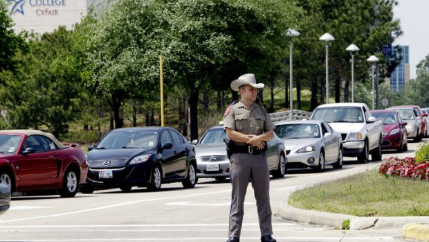 In lockdown: A Texas State Trooper stands at an entrance of the campus.