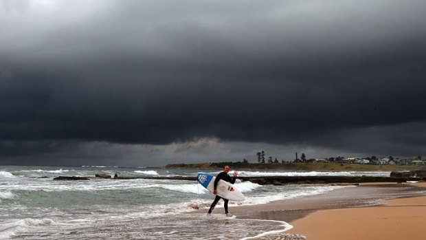 Dark day ahead &#8230; a surfer at Thirroul leaves the surf while a rainbow appeared over Manly Beach yesterday. The low pressure cell is expected to bring extreme weather to Sydney and southern regions this morning.