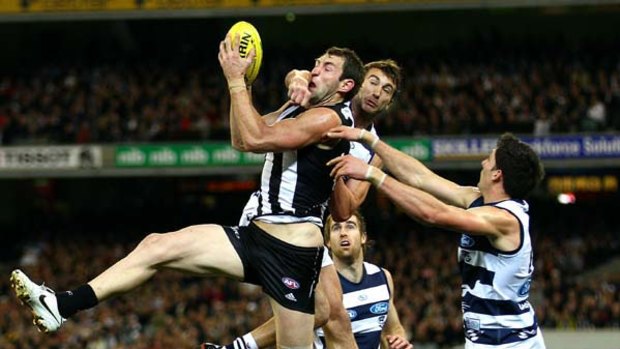 Travis Cloke marks under pressure from Corey Enright in the round-19 game.