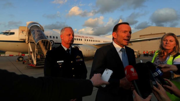 Prime Minister Tony Abbott in the  Netherlands said the photos believed to be of a Sydney boy holding a decapitated head showed 'barbaric' nature of ISIL.