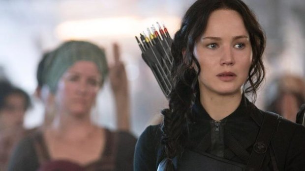 Ready for action: Jennifer Lawrence as Katniss Everdeen in a scene from <i>The Hunger Games: Mockingjay Part 1.</i>