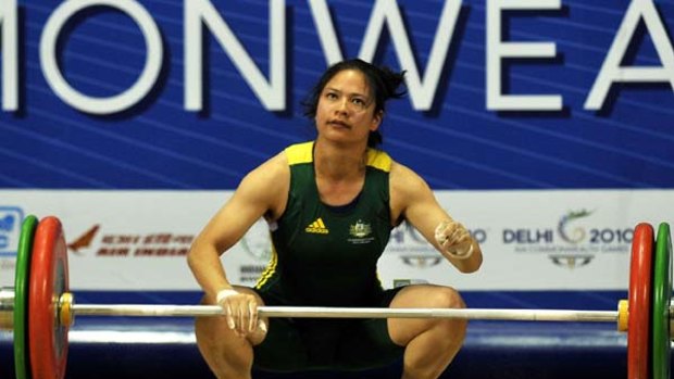 Australia's Seen Lee misses a lift during the women's 58 kg weightlifting snatch.