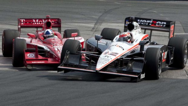 Dario Franchitti, left,  makes contact with Will Power, during the IndyCar race in  Toronto on Sunday.