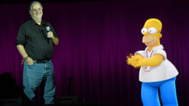 Homer help ... Matt Groening takes questions on plans for a <i>Simpsons</i>/<i>Family Guy</i> crossover episode with a little assistance from his most famous creation.