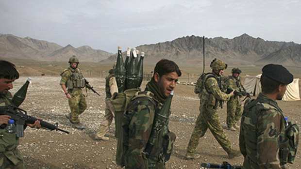 Dangerous work: Australian and Afghan soldiers on patrol in search of insurgents.