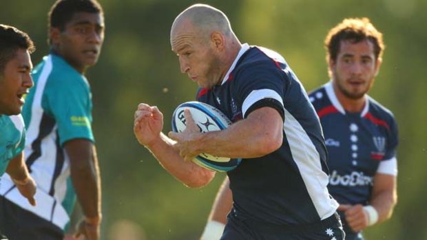 Stirling Mortlock of the Rebels runs in to score a try.