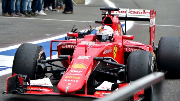 Blowout: Sebastian Vettel returns to pit lane during the Belgian Grand Prix.