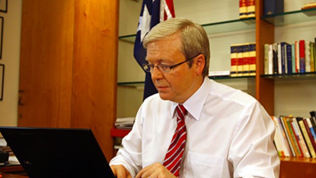 Busy... Prime Minister Kevin Rudd conducts a live web chat discussing climate change from a laptop computer in his Parliament House office in Canberra in August. Mr Rudd is said to only sleep a few hours a night.