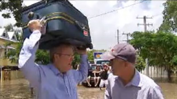 Kevin Rudd helping out flood victims in Norman Park earlier this week.