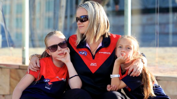Demons fans gather at Federation Square ahead of Jim Styne's funeral at St Paul's Cathedral.
