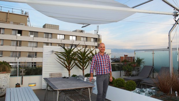 Jock Gammon from Junlefly on the roof of a Cremorne apartment where he has designed an outdoor living area.