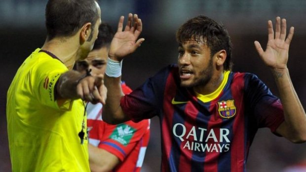 Barcelona's Neymar argues with the referee.