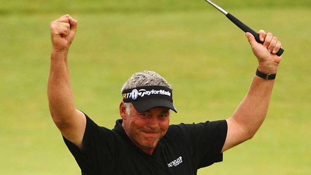 Winner ... Darren Clarke punches the air after sinking his final putt on the 18th hole.
