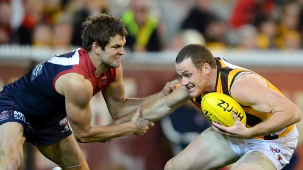 Tied up: Jarryd Roughead tries to break clear of a Jared Rivers tackle last night.